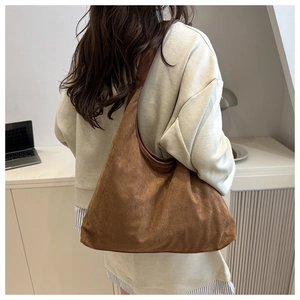 Detail view of large brown velvet leopard tote bag showing its soft capacity on shoulder