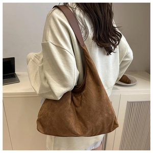 Detailed back view of a large brown suede tote bag with comfortable wide shoulder straps