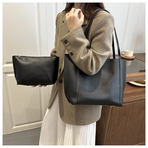 Chic black PU leather tote bag and pouch set styled with a stylish wool coat and skirt
