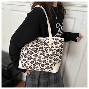 Detailed close-up of a vintage leopard print tote bag with cream-colored straps