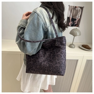 Detail view of large leopard print tote bag with thick handles for casual autumn style