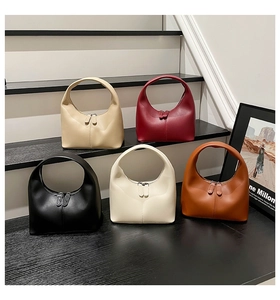 Detailed display of crescent-shaped leather handbags in beige, burgundy, and black