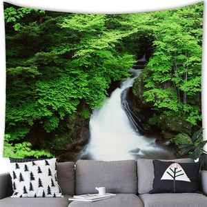 Detailed close-up of a forest waterfall tapestry hanging above a modern grey sofa