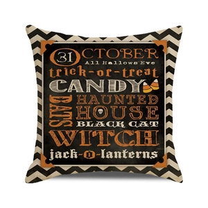 Macro shot of Halloween cushion cover with festive witch and jack-o-lantern typography