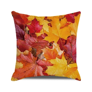 Square autumn throw pillow featuring vibrant maple leaf patterns on a textured fabric
