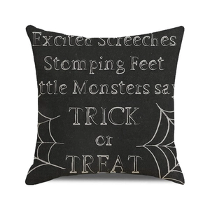 Macro detail of Halloween pillowcase with white spider web and Trick or Treat typography