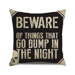 Halloween decorative pillow cover with skull graphic and distressed warning text on black