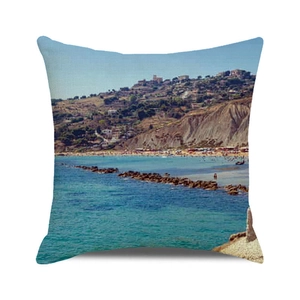 Close-up of a square linen cushion cover with a Mediterranean seaside landscape print