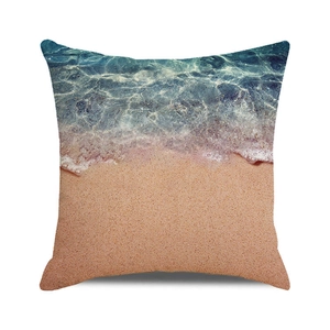 Detailed close-up of beach and ocean wave print on a square decorative cushion cover