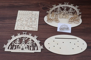 Macro detail of laser-cut wooden nativity scene components with festive church designs