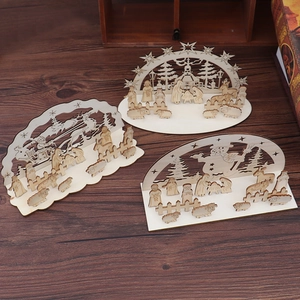 Close-up of laser-cut wooden Christmas desktop ornaments with nativity and Santa scenes