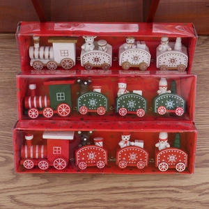 Three sets of wooden Christmas train ornaments in red, green, and white festive packaging