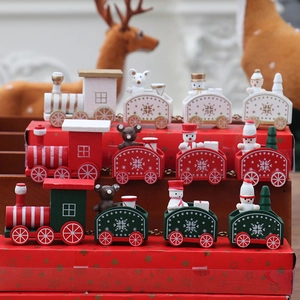 Detailed view of red, green, and white wooden Christmas train sets with snow patterns