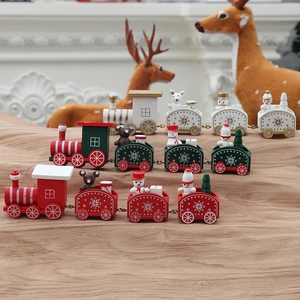 Macro detail of wooden Christmas trains with snowmen and bear figures on festive cloth