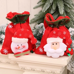 Christmas drawstring gift bags with plush Santa and snowman decorations for holiday treats