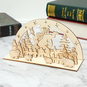 DIY Christmas wooden snowman decoration on white marble table with winter scenery details