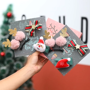 Detailed view of Christmas hair clips set with Santa, antlers, and ribbon bows