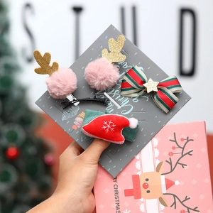 Detail view of 4-piece Christmas hair accessories set with reindeer antlers and star bows