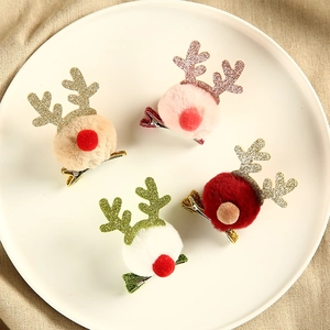 Four plush reindeer antler hair clips in various colors for Christmas holiday hair styling