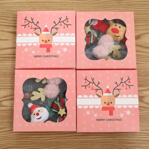 Pink Christmas gift boxes with plush Santa, reindeer hair clips and festive bow accessories