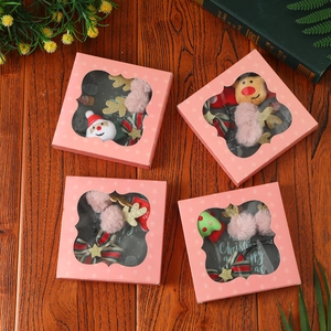 Christmas hair accessory gift set with Santa and reindeer themes in pink boxes