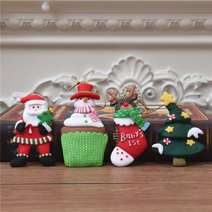 Detail of four festive polymer clay Christmas charms including Santa and a reindeer sock