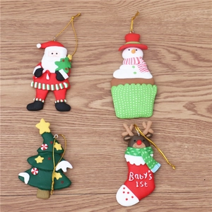 Macro detail of 4-piece polymer clay Christmas ornaments with festive gold hanging strings