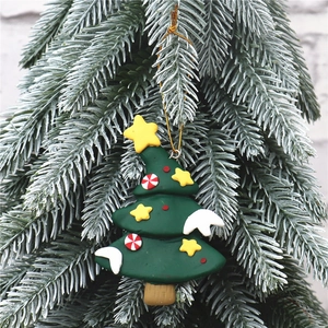 Detailed view of handmade clay Christmas tree ornament with candy buttons and top star
