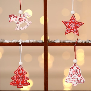 Set of 12 festive wooden Christmas tree ornaments featuring stars and bells in a gift box