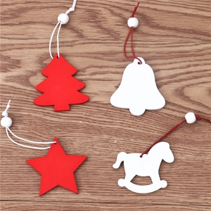 Detailed view of red and white wooden Christmas ornaments on rustic wood background