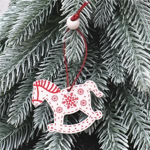 Detail of wooden Christmas rocking horse pendant with red snowflake patterns on tree