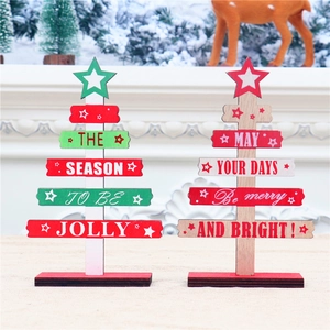 Detail of DIY wooden mini Christmas trees with festive patterns and stable base on a desk
