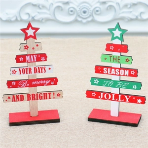 Close-up of DIY wooden mini Christmas trees with festive holiday slogans for desk decor