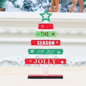 Detail of wooden mini Christmas tree with festive lettering on a white mantel fireplace