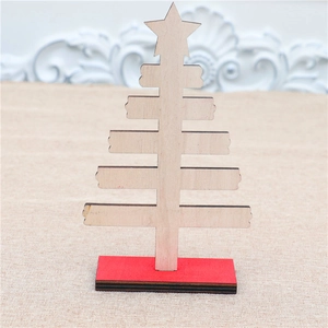 Detail view of mini wooden Christmas tree with red base for desktop holiday decoration