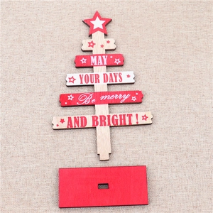 Flat lay of unassembled wooden Christmas tree decor with festive typography on burlap