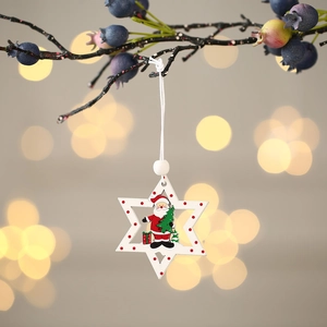 Detail of wooden star Christmas ornament with Santa Claus hung on a festive branch