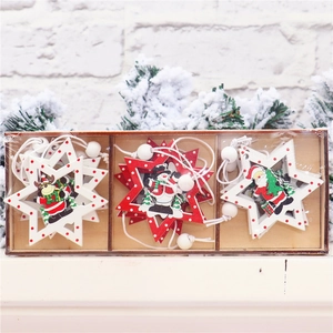 Detail of DIY wooden Christmas tree pendants featuring Santa and reindeer in a gift box