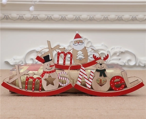Detalle de figuras navideñas de madera pintadas con Papá Noel y Reno decorativo