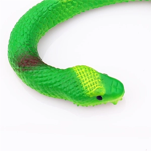 Close-up of green rubber toy snake showing realistic scale texture and yellow head markings