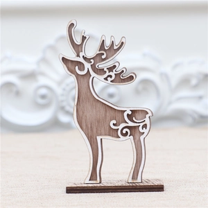Detail of wooden reindeer ornament with intricate cutout patterns and a white base