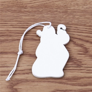 Détail d'un ornement de Noël blanc en bois irrégulier avec une cordelette en coton