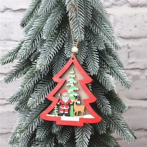 Detail of wooden Christmas tree star hanger with Santa and reindeer on snowy pine branch