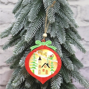 Illuminated red wooden Christmas star ornament with a scenic 3D miniature on a tree