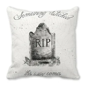 Macro detail of Halloween pillowcase featuring tombstone and spider web on peach skin fabric