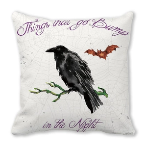 Close-up of Halloween peach skin pillow cover with crow and bat print on white base