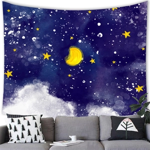 Detail of artistic star and moon wall tapestry hanging above a gray sofa in a room