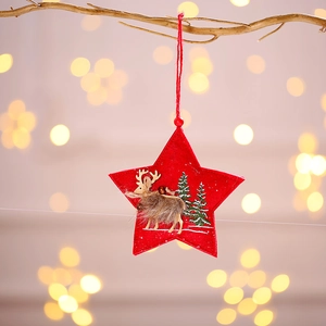 Red felt star Christmas ornament featuring a 3D elk and pine trees on a cozy light background