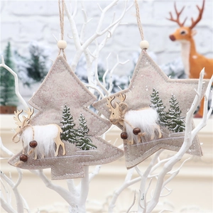 Detailed view of grey felt Christmas tree and star ornaments with wooden reindeer and fur
