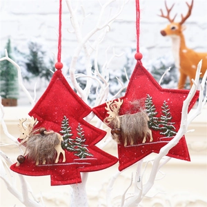 Detail of red Christmas felt ornaments with wooden reindeer hanging on white branches